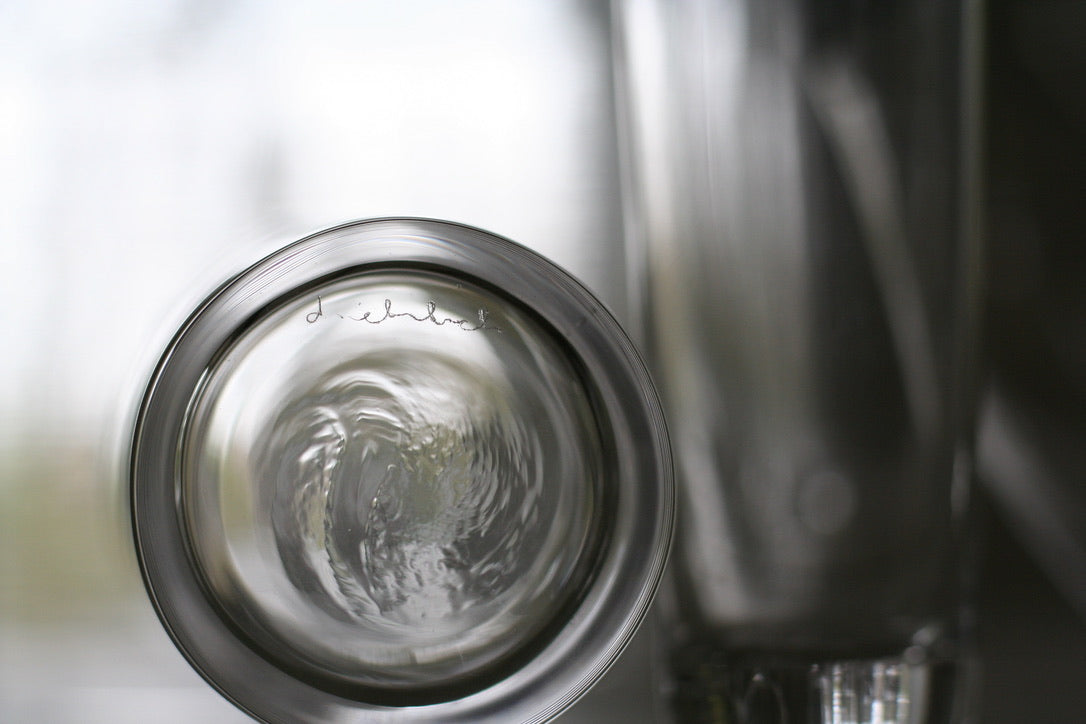 Hand written signature d.ehrlich etched on bottom of crystal glass with handblown swirl on the bottom of the glass
